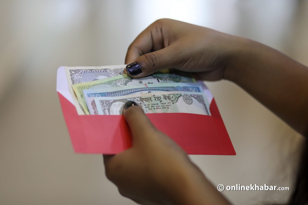 Taking money out of an envelope. Photo: Aryan Dhimal