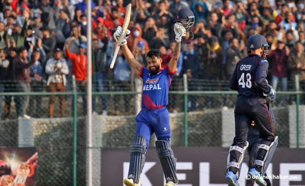 Kushal Bhurtel raises his bat after scoring a century during a match against Namibia under the ICC Men's Cricket World Cup League 2, in Kathmandu, on Tuesday, February 14, 2023. Photo: Bikash Shrestha