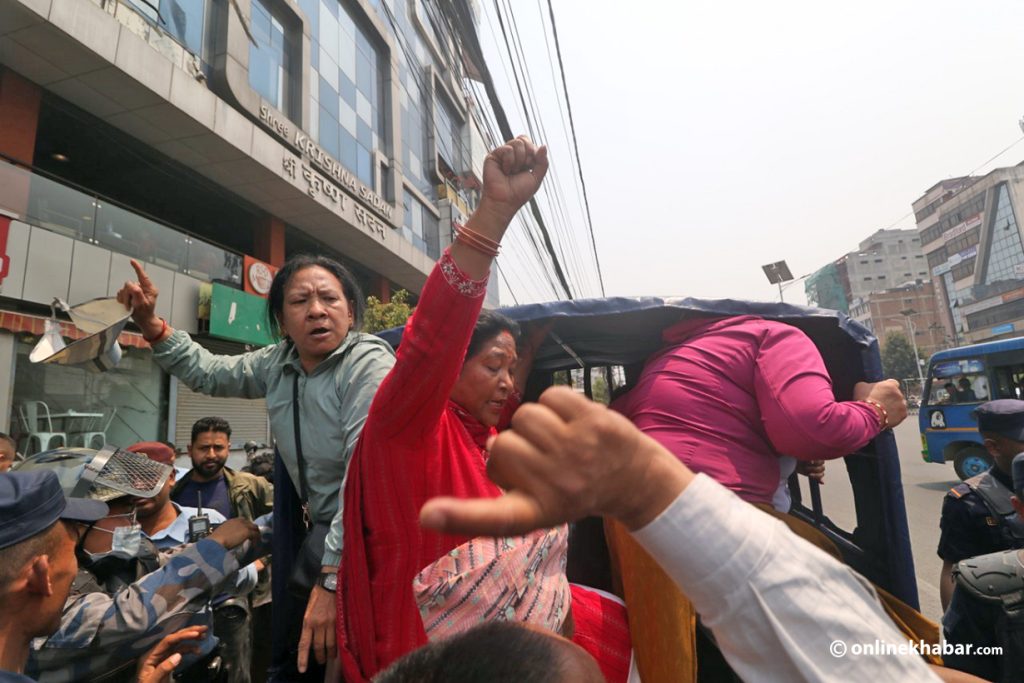 Police detain a group of armed conflict survivors who were protesting at Naya Baneshwar, Kathmandu, on Tuesday, April 18, 2023. Photo: Aryan Dhimal