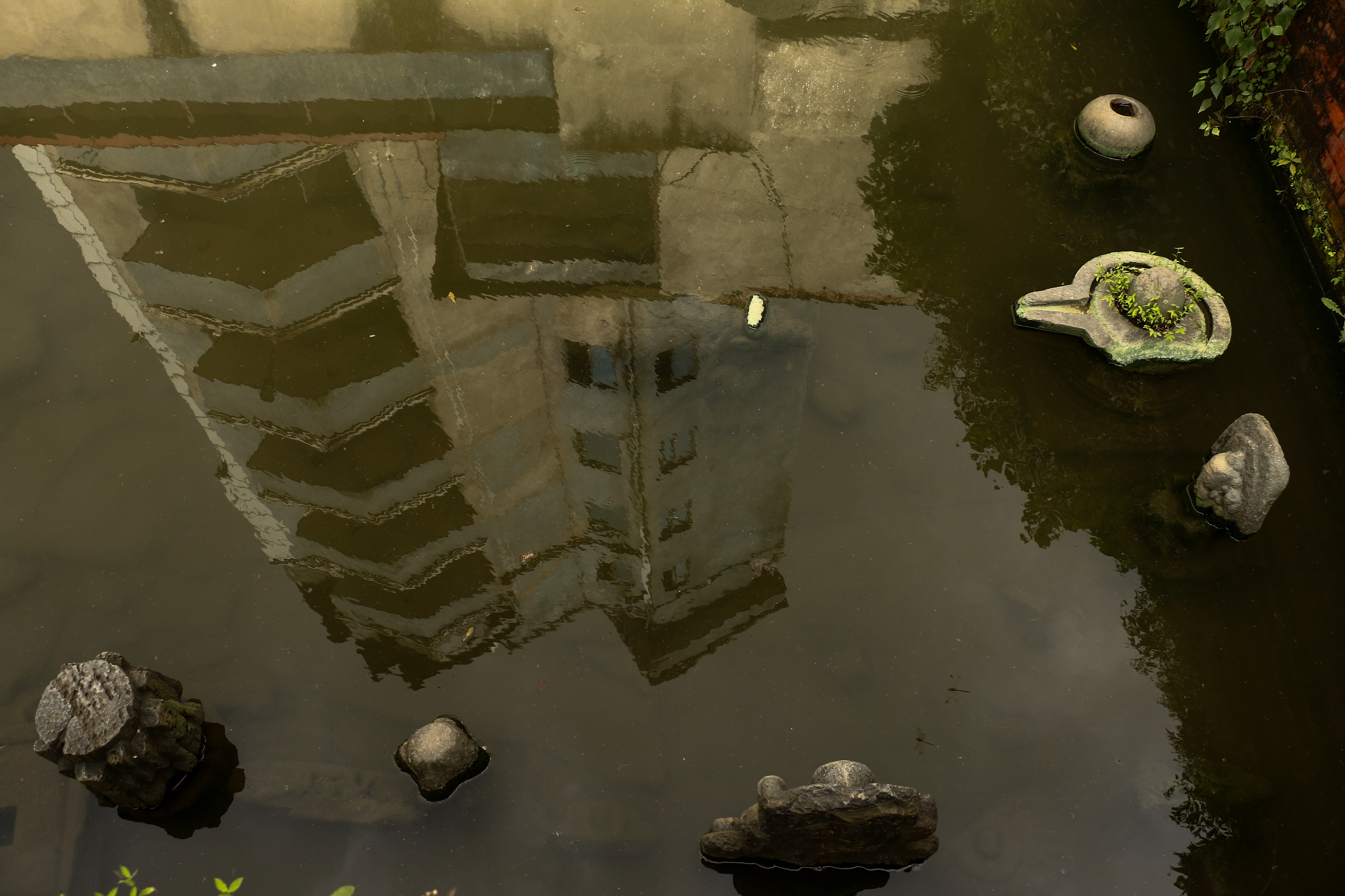 A building reflected in the water at desolated Yangal Hiti. Locals say the hiti dried up after the construction of the building.