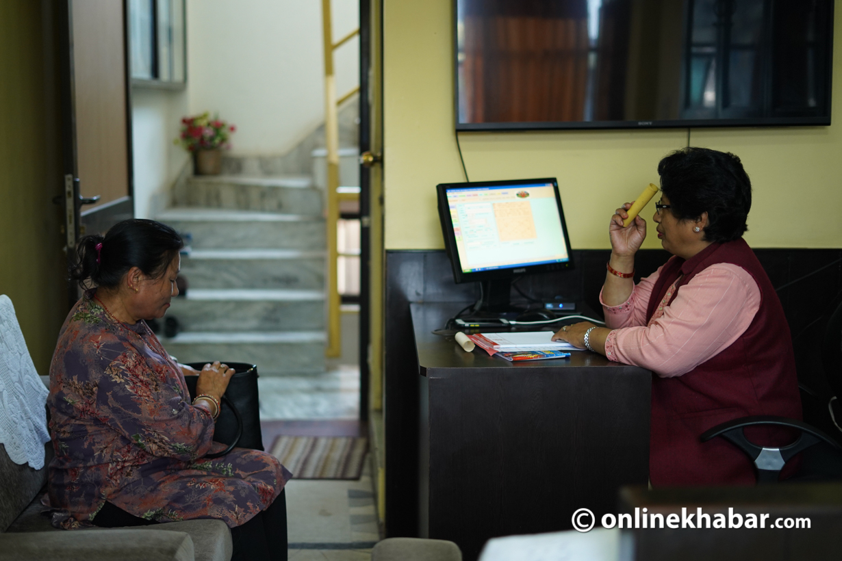 Astrologer Rati Devi Joshi talks to her clients in her office at Kathmandu. Photo: Aryan Dhimal
