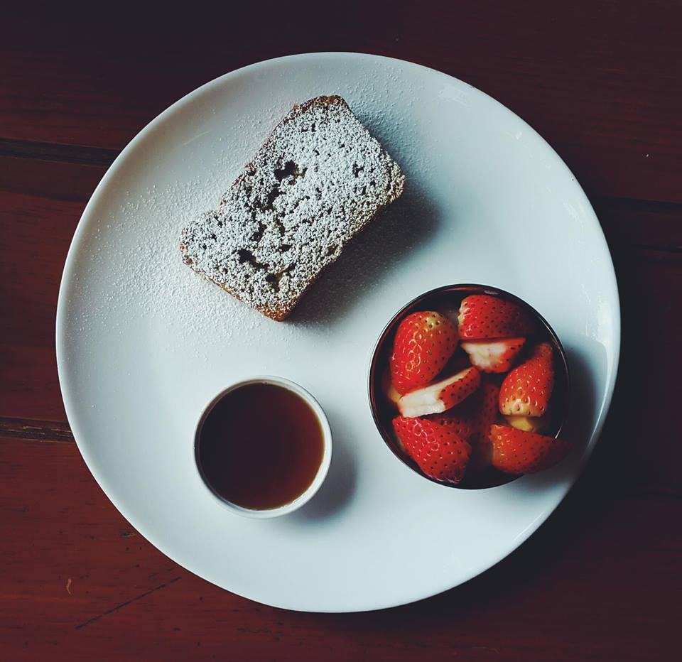 Toasted banana bread with maple syrup and strawberries cafe soma