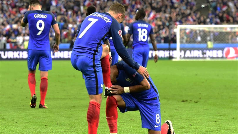 Antoine Griezmann (R) of France shoe is kissed by Dimitri Payet as he celebrates scoring their fourth goal during their UEFA EURO 2016 quarter final match against Iceland