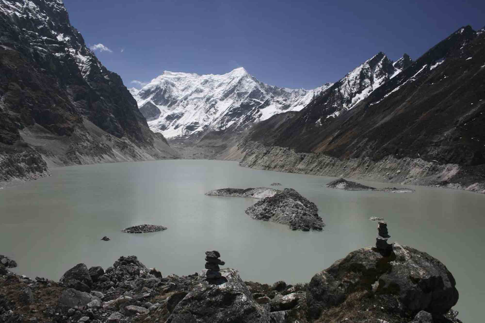 “Tsho Rolpa Glacial Lake: an example of potential threat behind the beautiful glacial lakes in the Rolwalling valley, Nepal. Tsho Rolpa is one of high priority potentially dangerous glacial lakes of Nepal Himalayas. As a result of climate change and fast retreating of glacier; the lake had increased from 0.23 square kilometer to 1.53 square kilometer in the last five decades (Mool et al. 2010, Press). The fast retreating glaciers and adjoining glacial lakes increasing the threats of glacial lake outburst flood (GLOF). GLOFs most likely would cause extensive effects on the downstream pose a threat to human lives and properties.” 10th May 2010. Dolakha, Nepal.