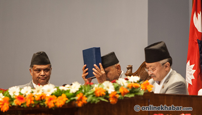Then President Ram Baran Yadav greets the constitution as he announces its commencement on September 20, 2015.