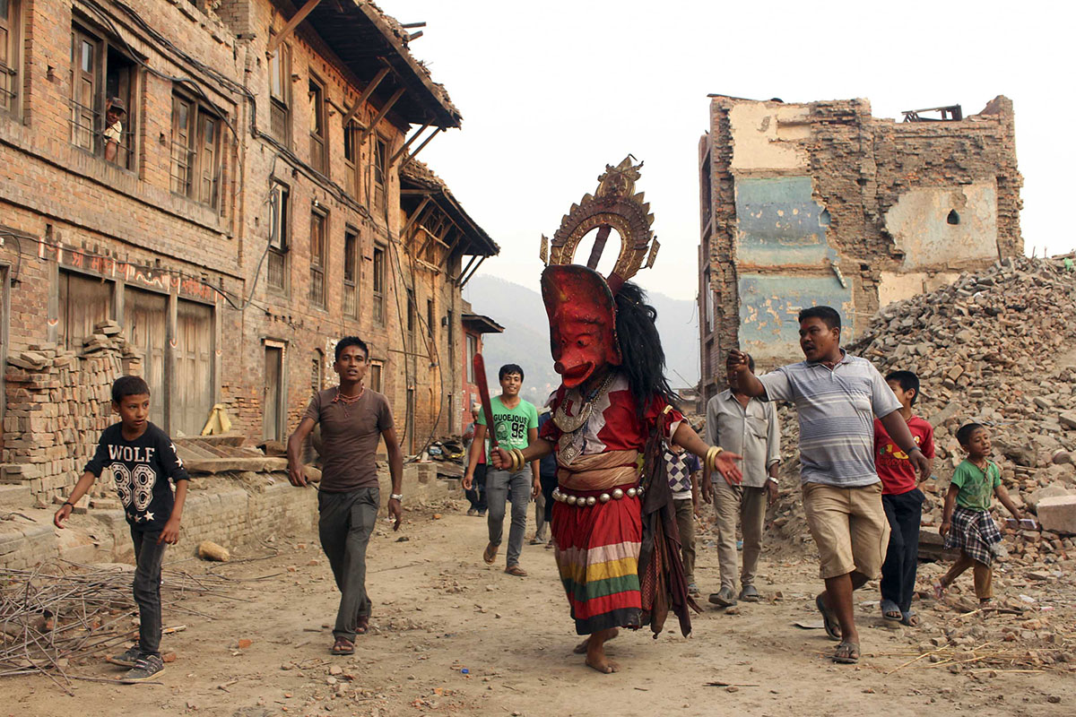 Masked Goddess Barahi surrounded by local devotees of Bhaktapur in the earthquake-hit area of Khacha. Barahi Goddess is worshipped as goddess who controls earthquake .
