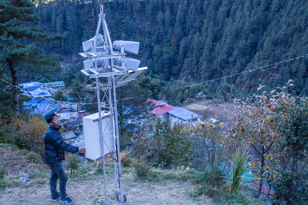 Nang thume Sherpa, member of Task Force for Glacial Lake Outburst Flood risk reduction shows the early warning system intslled in Fakding Village Solukhumbu, District Nepal. The early warning sytem will get autmated warning message from Automated Hydromet Sensor installed in Imja Glacial Lake.