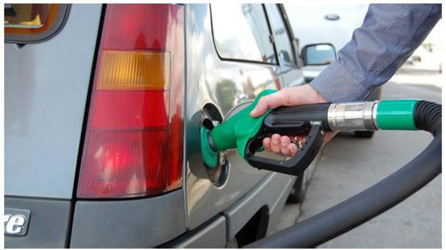 File: A car is being refilled with fuel.