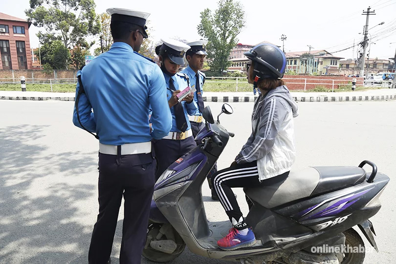 File: Traffic police interrogating a scooter rider