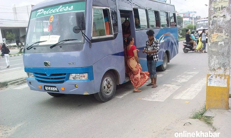 File: A conductor collects the bus fare from a passenger in Kathmandu
public transport fares
public bus fares