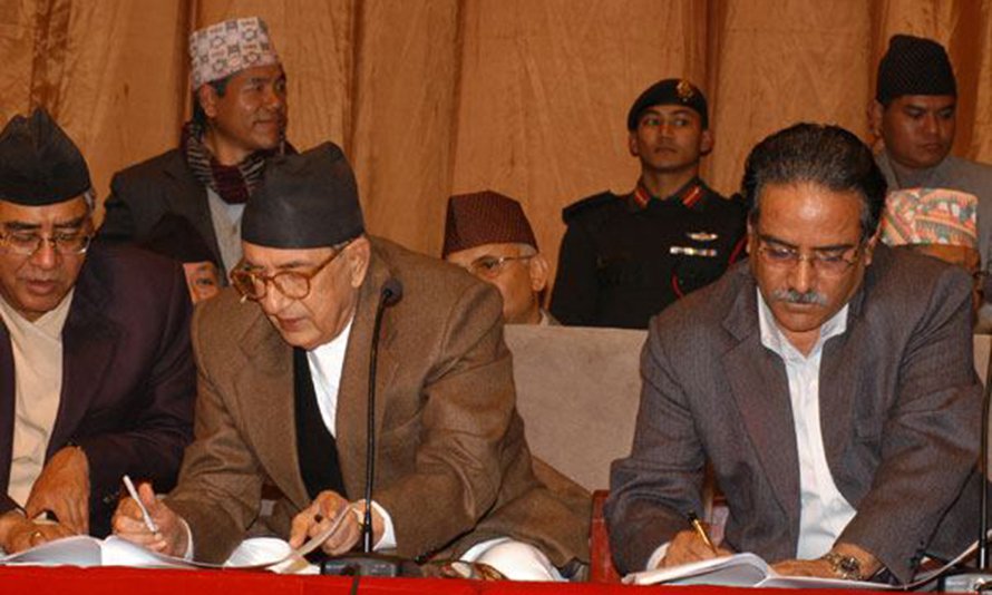 Then Prime Minister Girija Prasad Koirala and Maoist leader Pushpa Kamal Dahal sign the Comprehensive Peace Accord that aimed at delivering transitional justice in Nepal following the Maoist war, in Kathmandu, in November 2006.
