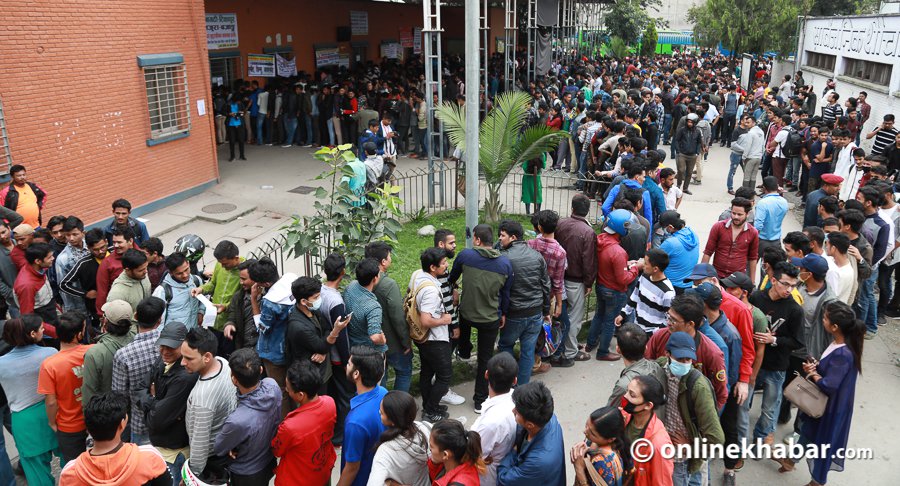 Dashain advance ticket booking File: People gather outside a bus ticket counter to book their tickets for Dashain travel