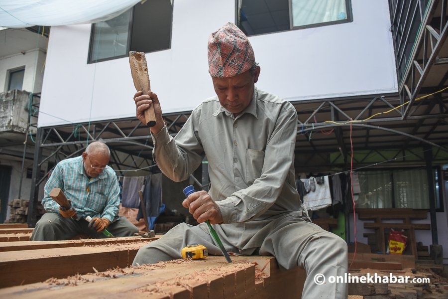 Workers preparing wood for the reconstruction of Kasthamandap