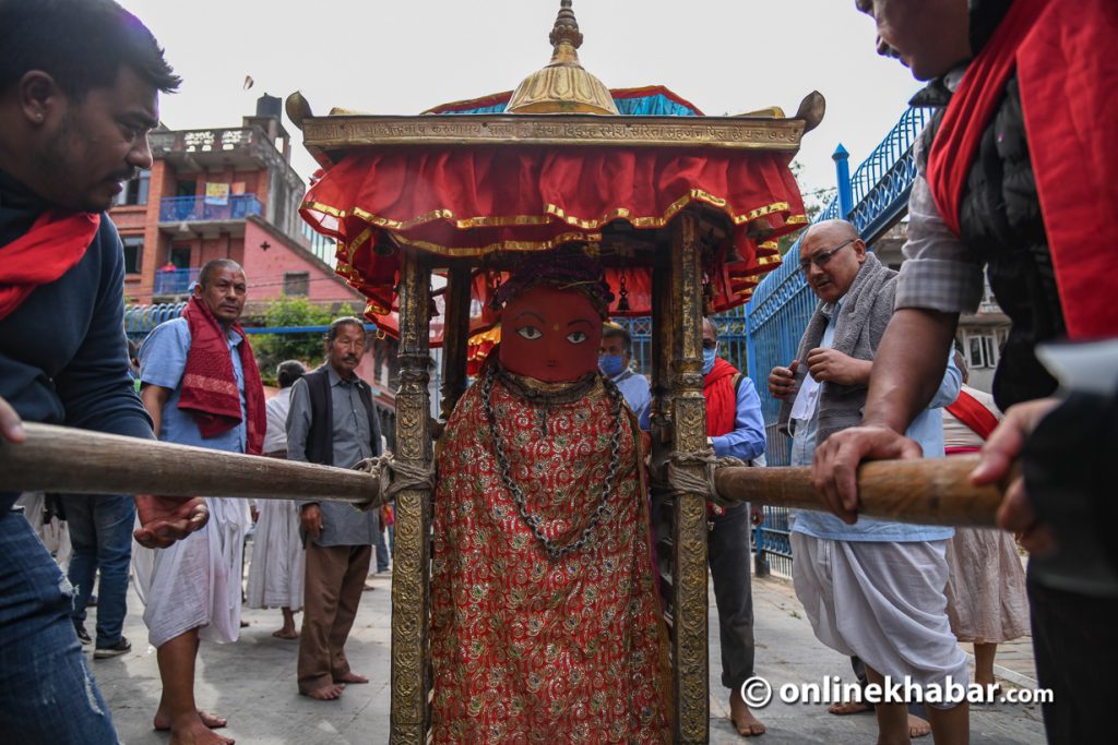 The statue of Rato Machhindranath is taken out for a bath, in Lalitpur, on Thursday, April 9, 2020.