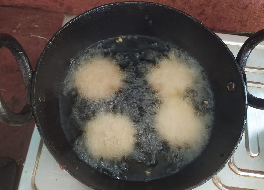 Deep frying the thekuwas in hot oil in low-medium flame