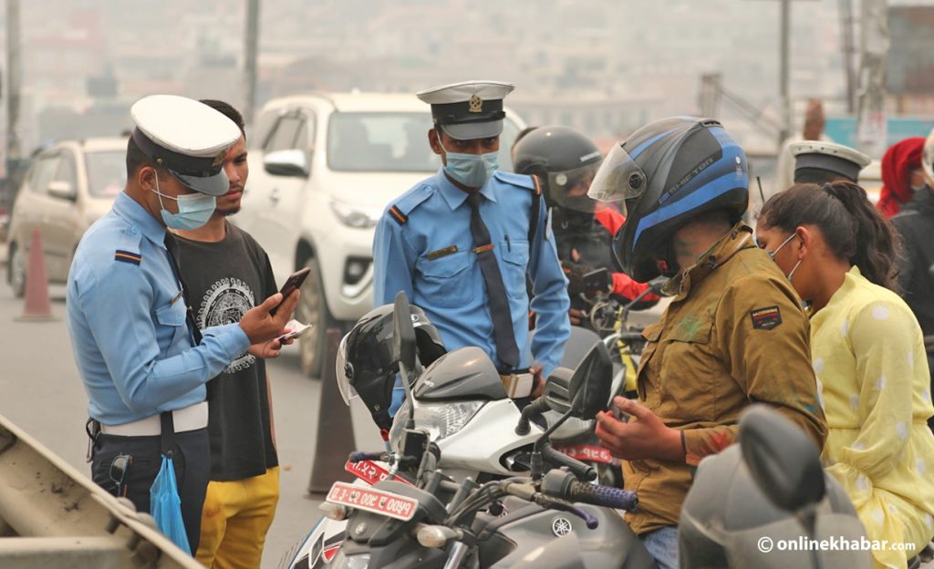 Traffic police interrogate a motorbike rider in Kathmandu. 