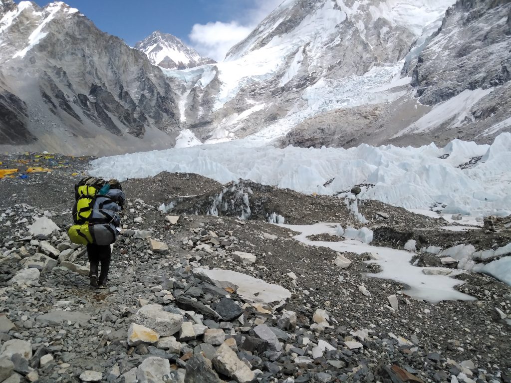 A porter carries a bags of mountaineering expedition companies to Everest Base Camp. Photo: Shashwat Pant