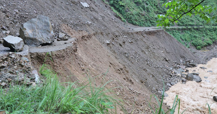 File: A section of the Butwal-Palpa road along the Siddhartha Highway is destroyed by a landslide, in June 2021. natural disaster died