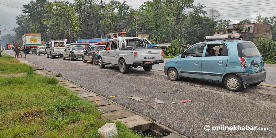 File: Vehicles wait for the Muglin-Narayangadh road to reopen after several landslides, in Chitwan, on Friday, July 2, 2021.