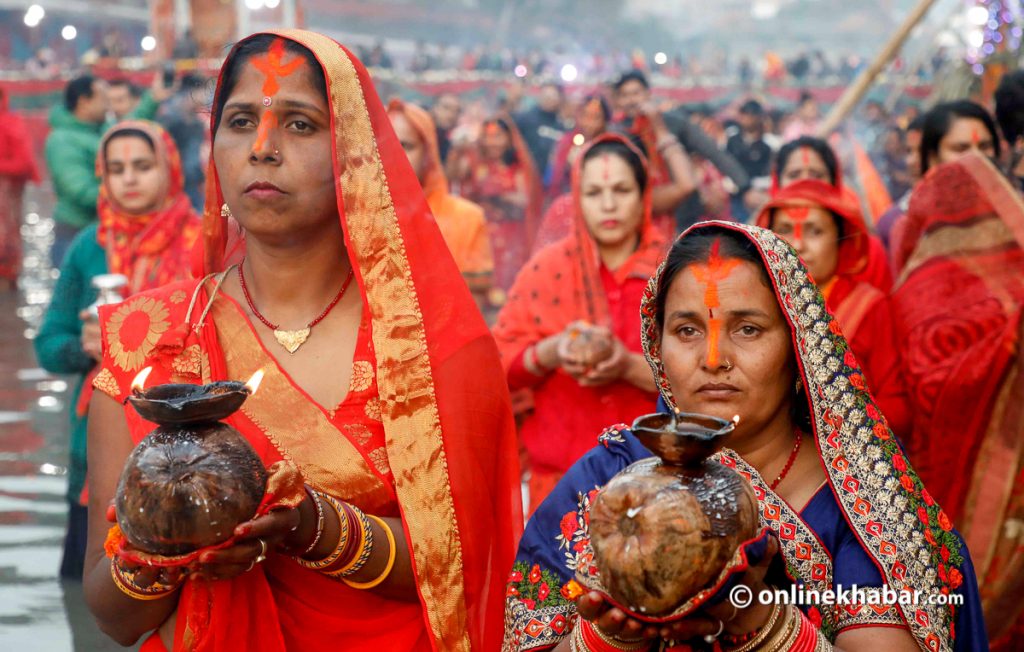 Women worshipping Chhati Maiya and Sun during Chhath celebration.