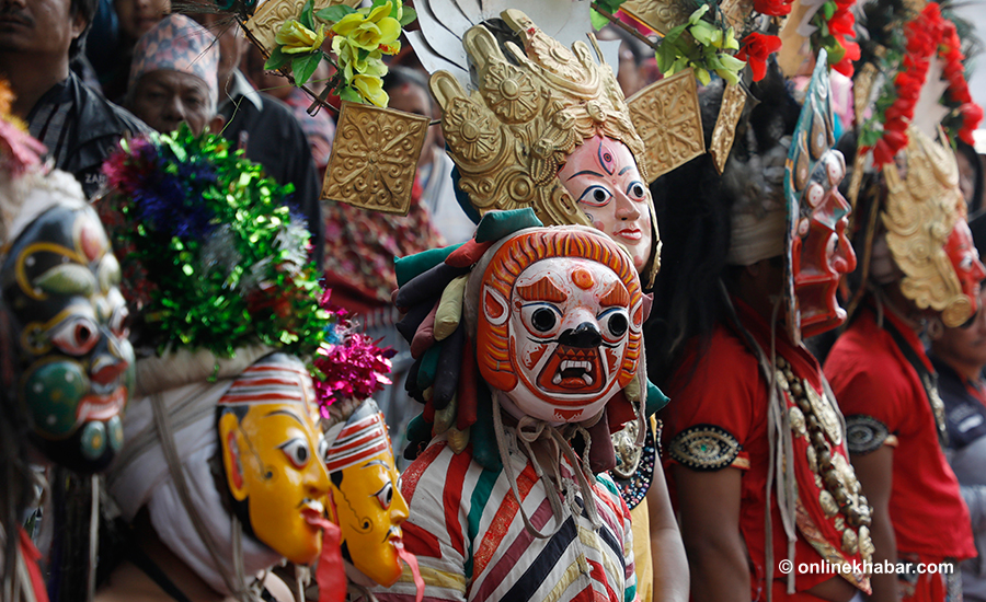 File: Masked faces during a Nepal Sambat New Year celebration, 2019