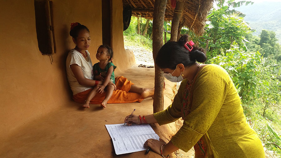 File: An enumerator collects data of a family during the national population census, 2021.