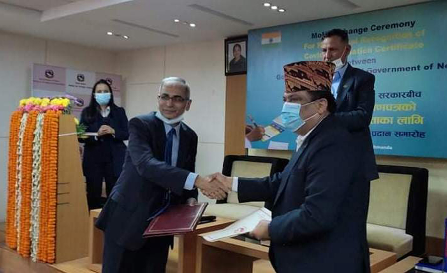 Nepal's Health Secretary Roshan Pokharel and Indian Ambassador Vinay Mohan Kwatra sign an agreement to recognise each other's Covid-19 vaccination cards, in Kathmandu, on Tuesday, November 23, 2021.