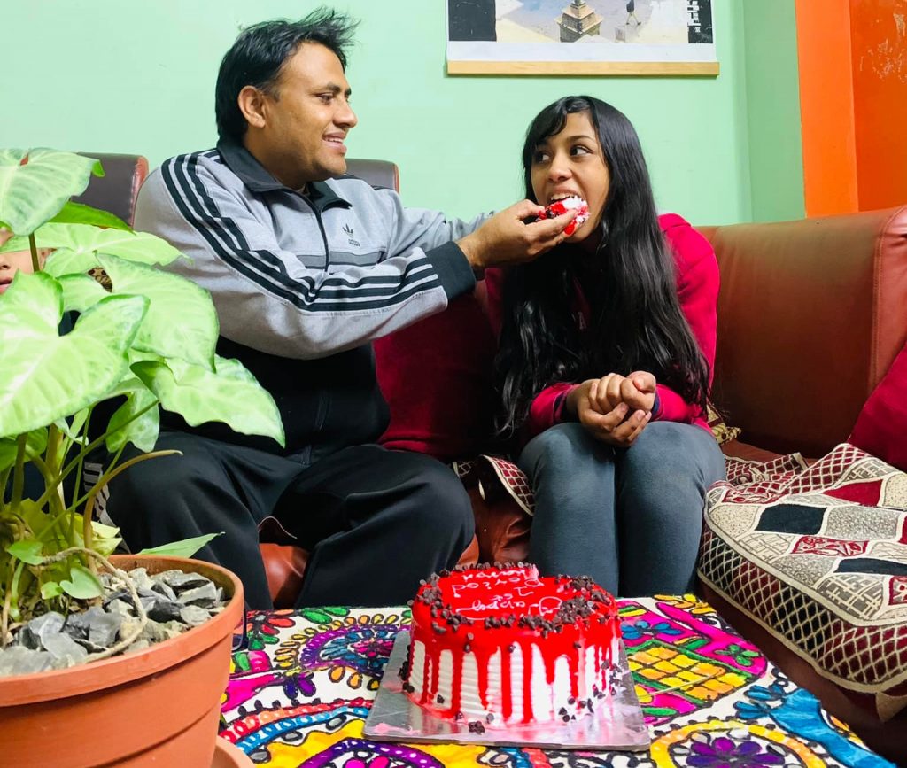 Subas feeding a slice of cake to his daughter, Sharon as she has first period. Photo: Namita Poudel