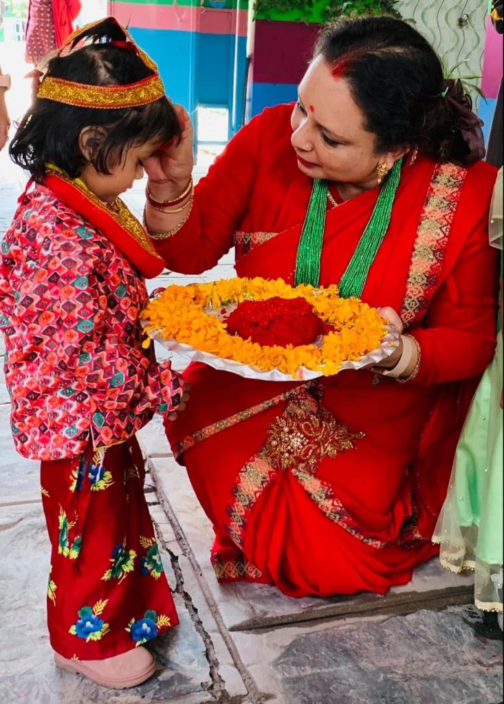 Kumud Bhatta putting tika on her students' forehead during a Tihar celebration. Photo: Courtesy Kumud Bhatta