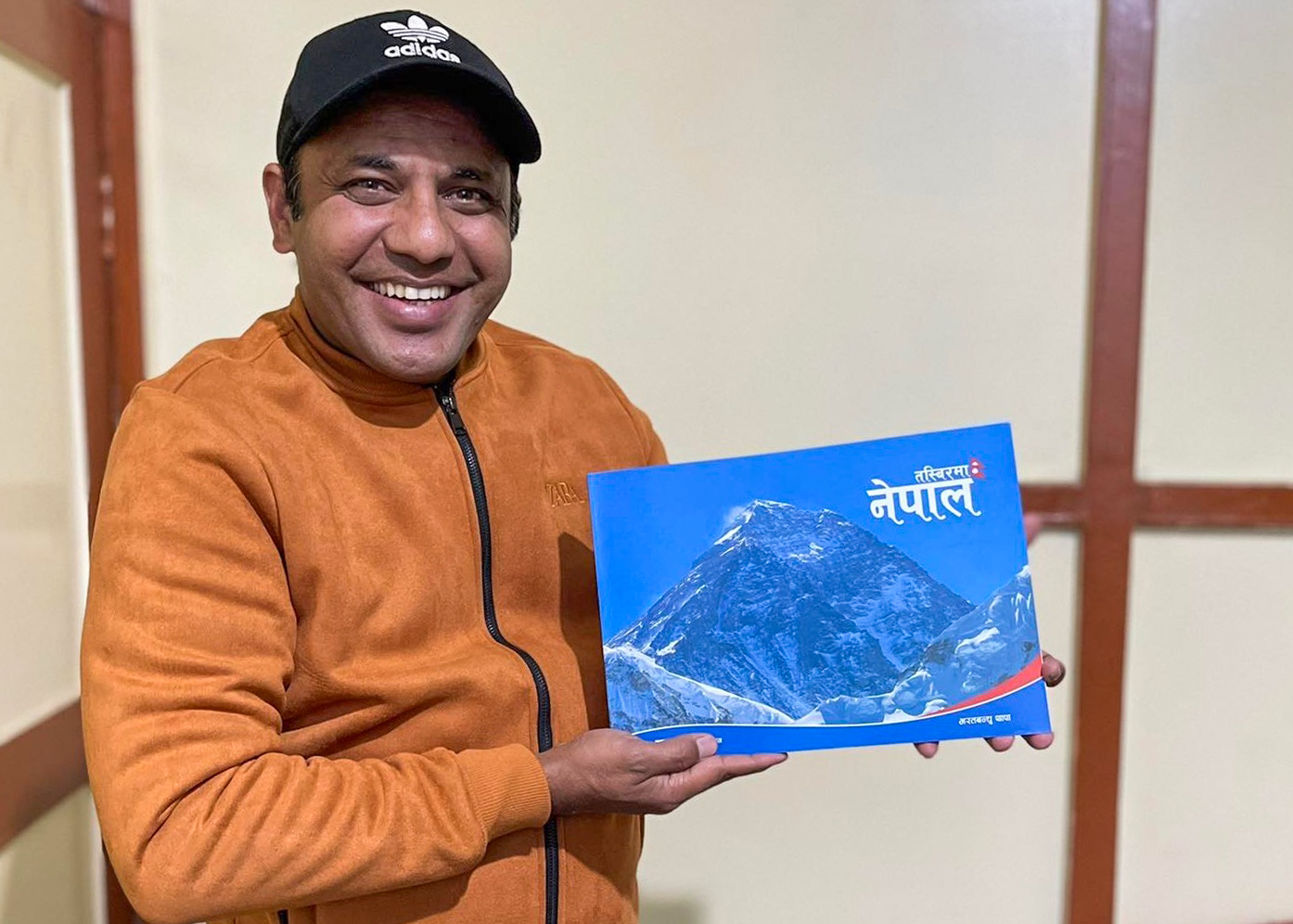Bharat Bandhu Thapa with his new photo book 'Tasbirma Nepal'