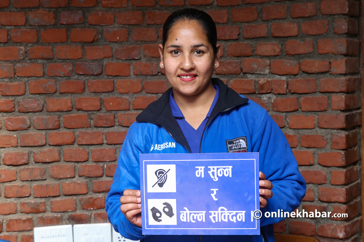 Chanda Nepal holding a sign