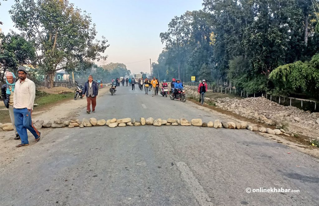 Locals in Krishnapur, Kanchanpur obstruct the East-West Highway following the death of a local in a car accident, on Sunday, December 5, 2021.
