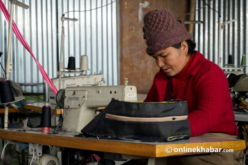 A woman stitching a bag in Aidi's factory. Photo: Shankar Giri