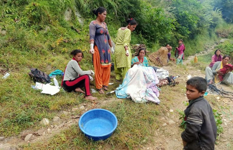 A mother giving birth on the road in Karnali. Photo: Tularam Pandey