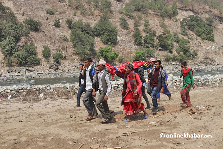 A pregnant woman is being taken to a health centre in Jajarkot of Karnali.