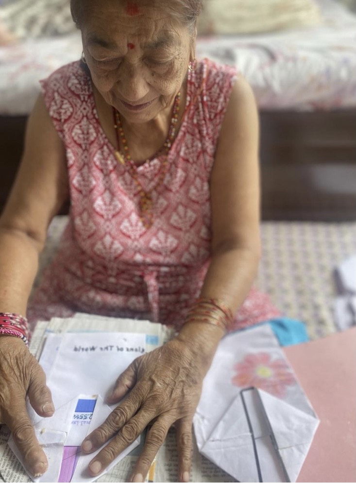 Jaya's grandmother making paper bags. Photo: Jaya Rajbhandari.