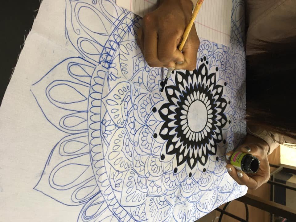 A student hand-painting the fabric at RIFA. Photo: Facebook page/RIFA