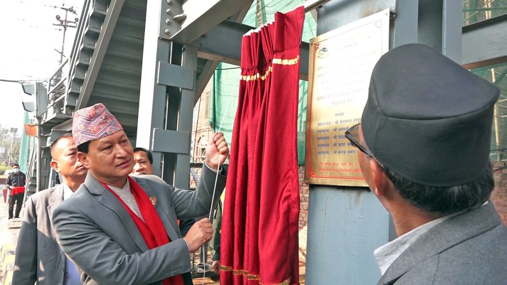 Kathmandu Mayor Bidya Sundar Shakya 'inaugurates' a bridge that is already in use, at Maitighar of Kathmandu, on Wednesday, March 16, 2022.