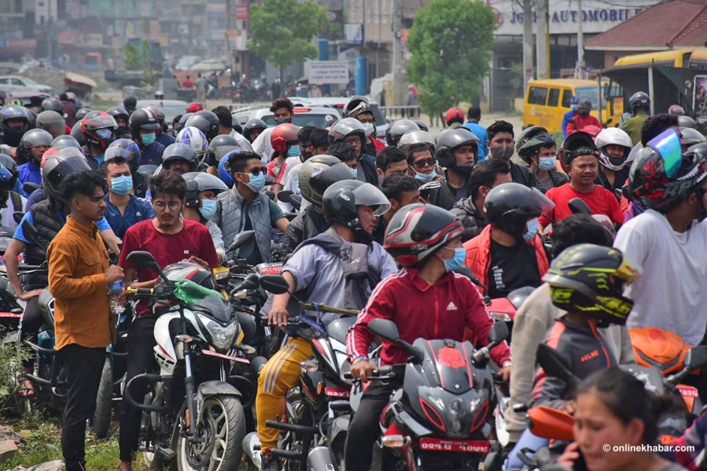A long line of motorcycles and scooters in front of a fuel station, to fill petrol, in Kathmandu, in April 2022.