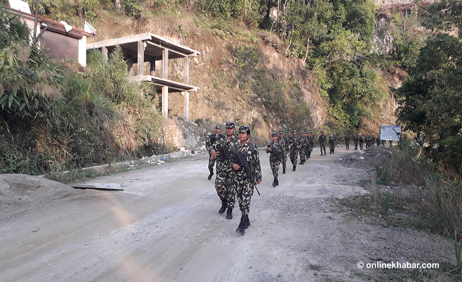 Army personnel patrol the voting booth area, in Bhattedanda of Lalitpur, on Friday, May 13, 2022. 