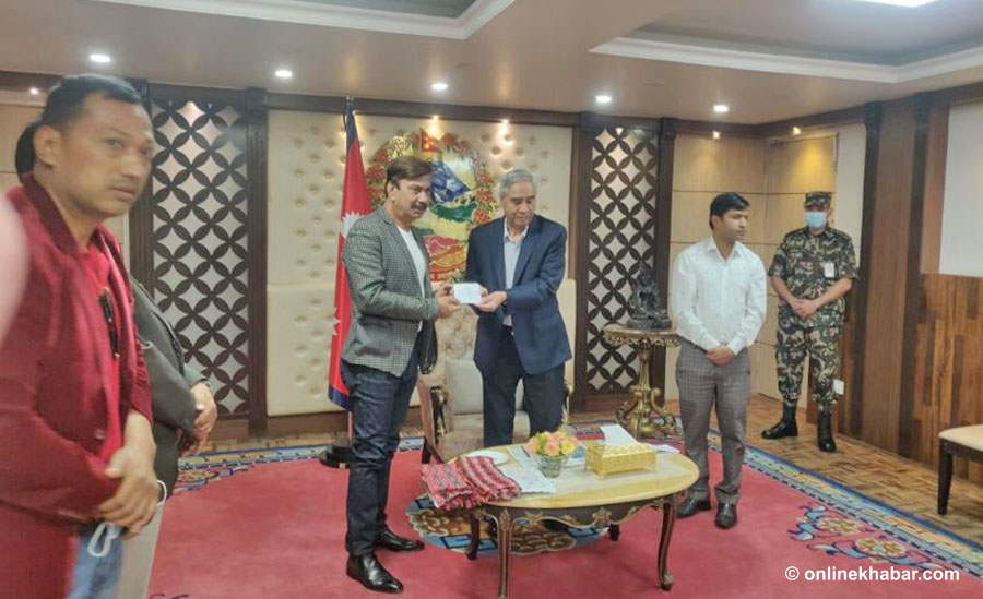 Actor Bhuwan KC is welcomed by Nepali Congress President Sher Bahadur Deuba in Kathmandu, on Tuesday, May 3, 2022.