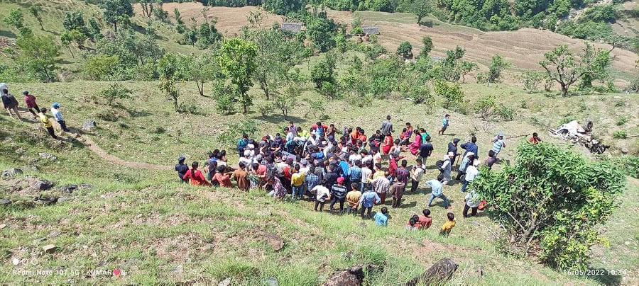 People gather after a vehicle falls off the road in Shailyashikhar of Darchula on Monday, May 16, 2022.