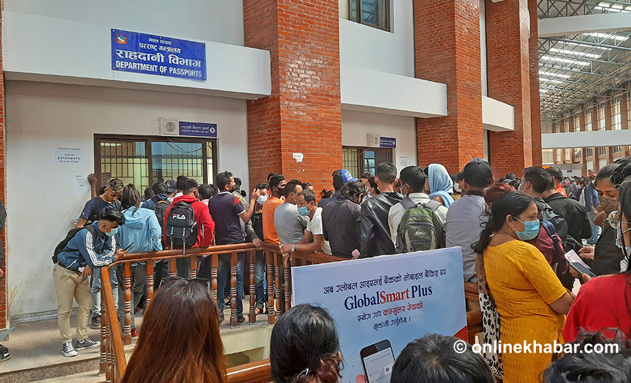 File: People gather to receive passports from the Department of Passport, in Kathmandu.