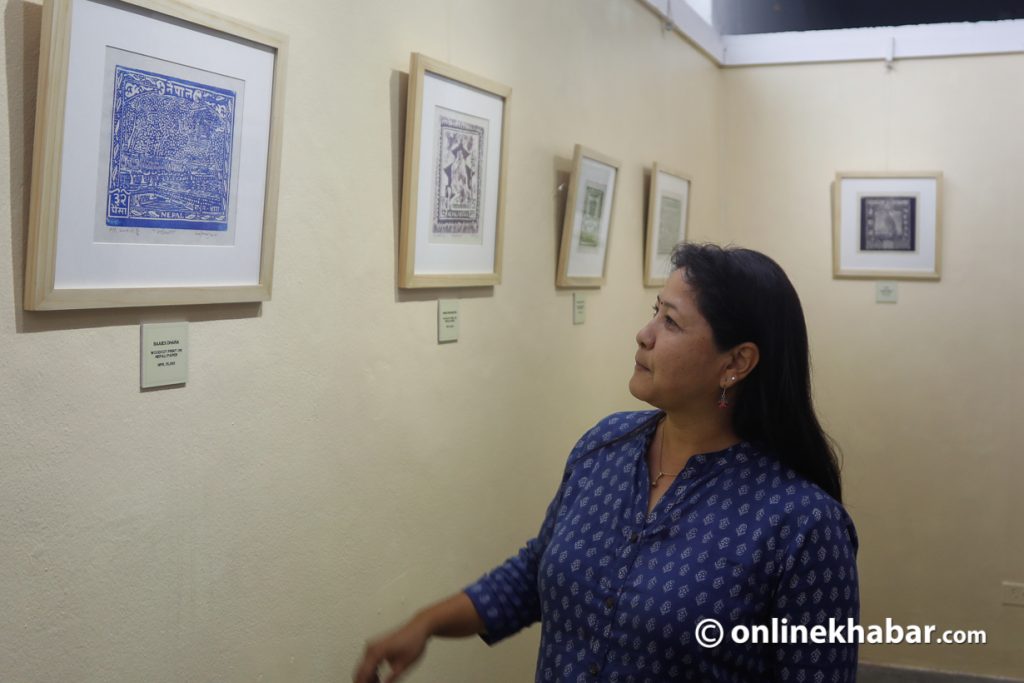 Artist Samjhana Rajbhandari explains her artworks at her woodcut print exhibition, Prints: A Tribute to the Past, about Nepal's postage stamp history, in May 2022. Photo: Bikash Shrestha