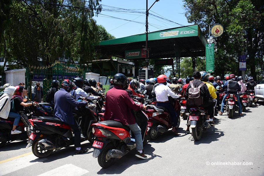 File: Motorbikers line up to refill petrol, in Kathmandu. Inflation