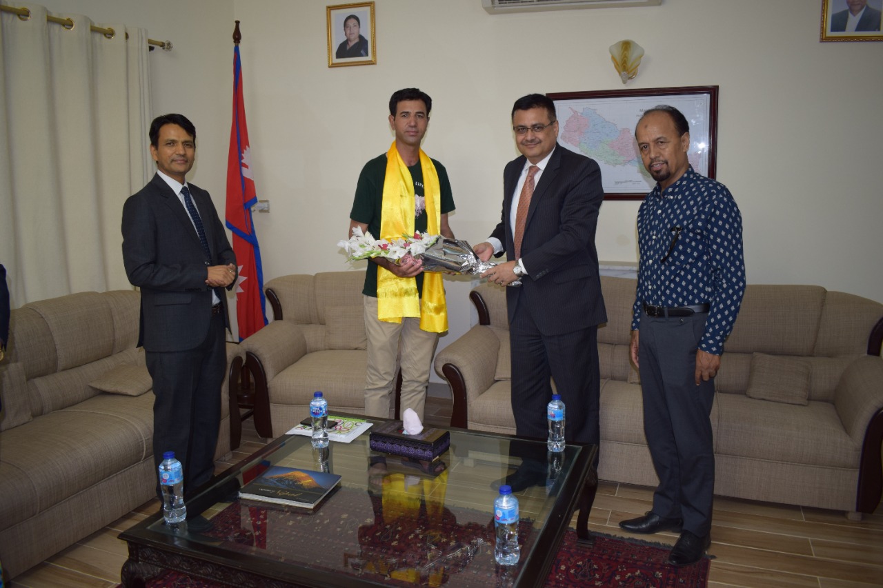 Nepali Ambassador to Pakistan, Tapas Adhikari, greets a mountaineer, during the Everest Day programme, at his office, in Islamabad, on Monday, May 30, 2022. Photo: Nepali Embassy in Islamabad