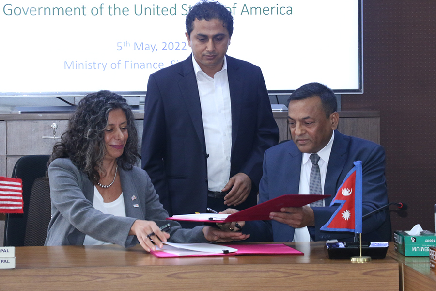 Coordination Division Chief Ishwari Prasad Aryal sign an agreement about the US government's grant support to help Nepal become a mid-income country, on Thursday, May 5, 2022.