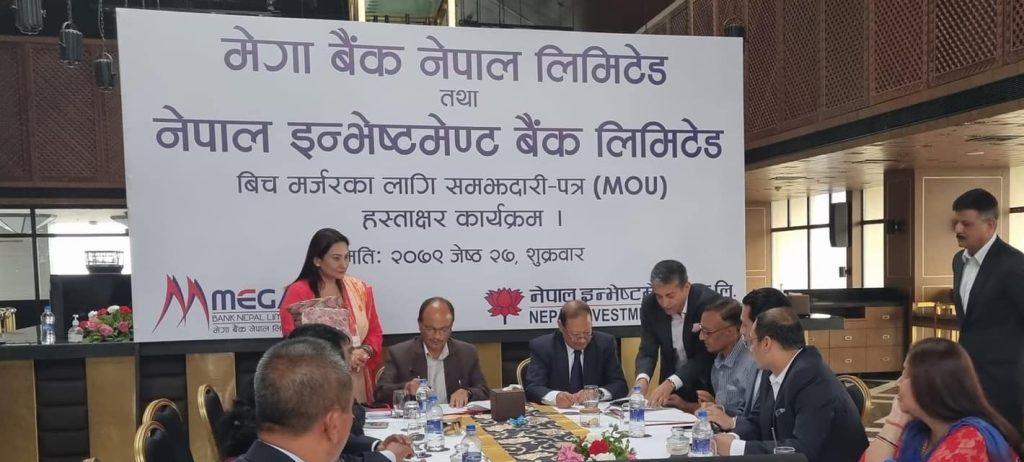 Officials of Nepal Investment Bank and Mega Bank sign a merger deal, in Kathmandu, in June 2022.