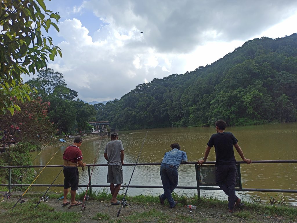 Fishermen wait for the catch in the Phewa lake of Pokhara, on Saturday, June 25, 2022. Pokhara lakes have been the hotspot of invasive species of fish in Nepal. Photo: Bikash Roka Magar