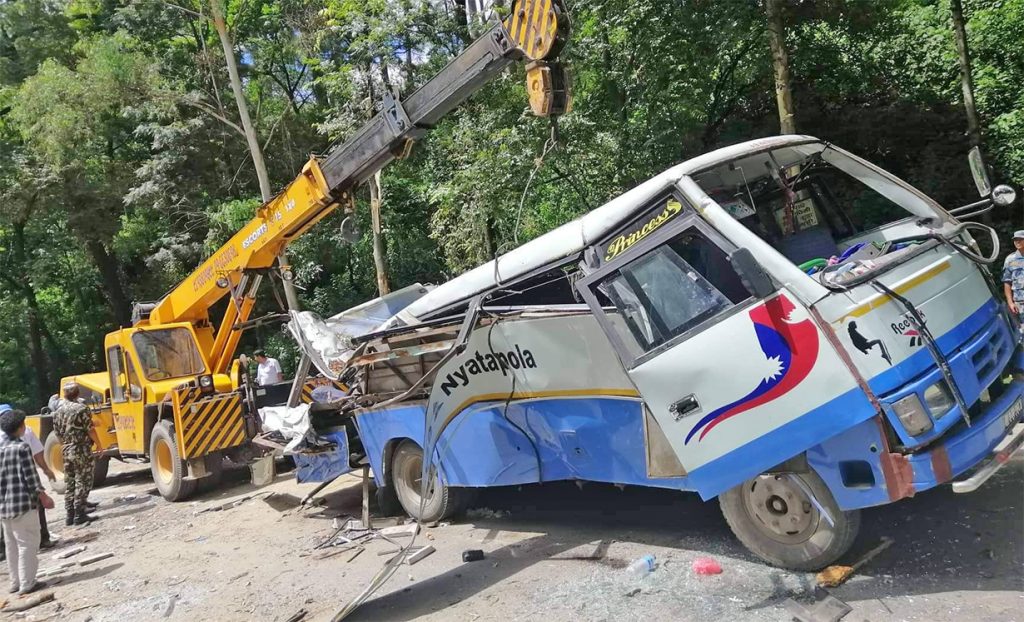 A tree falls on a moving bus and scooter in Bhaktapur, on Sunday, July 24, 2022.